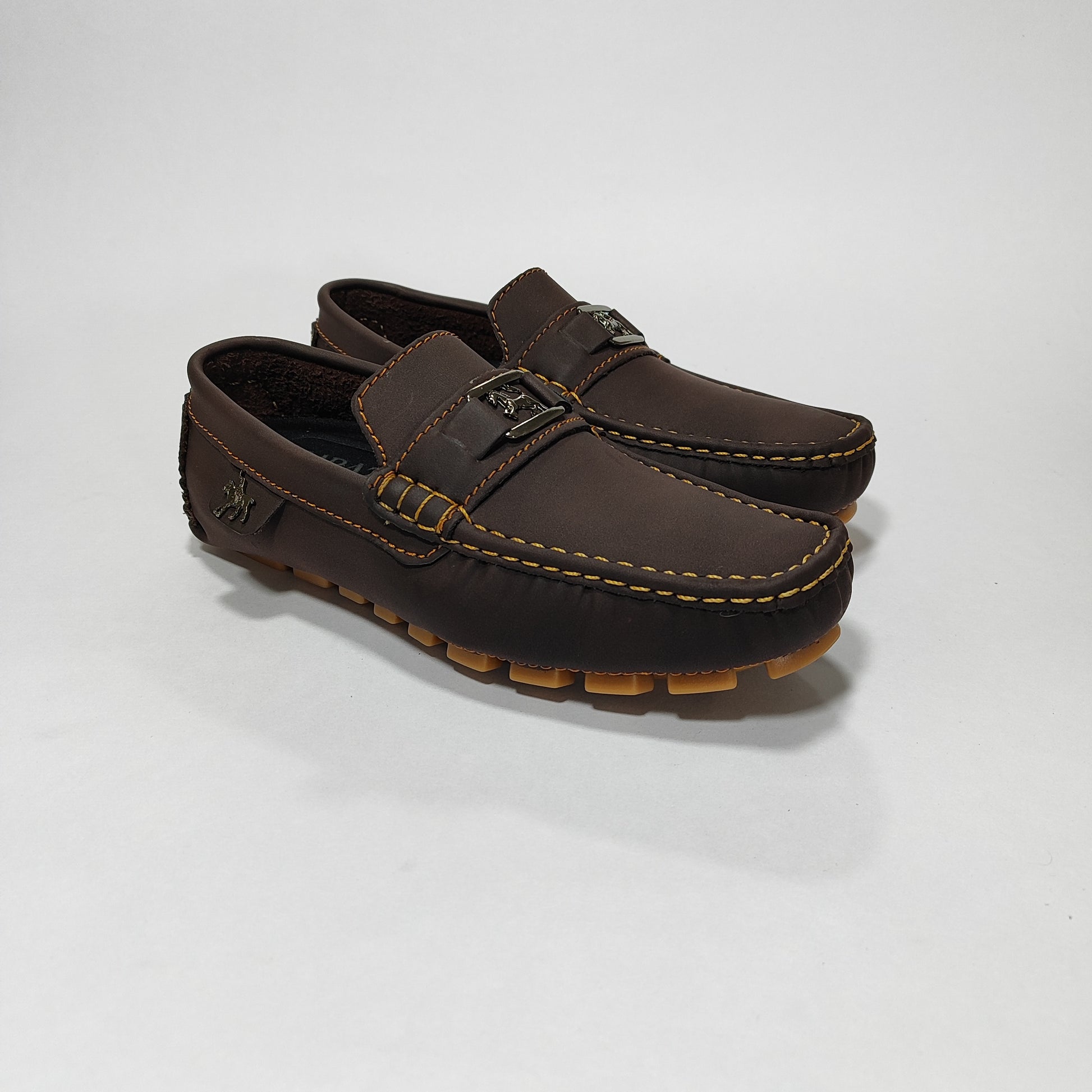 Mocasín café con aplique metálico de caballo y costuras contraste, vista tres cuartos